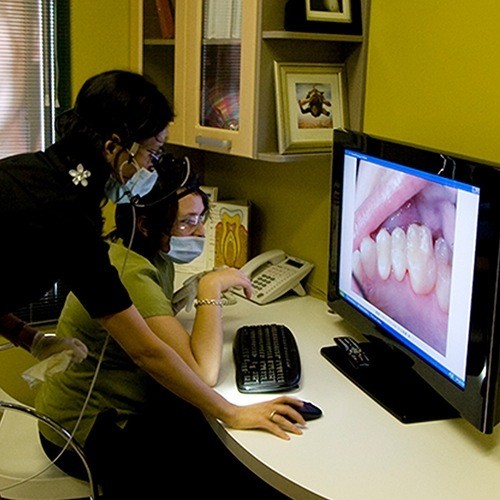 Dental implants surgically inserted into your jaw or maxilla bones and provide a foundation for long-term replacement teeth
